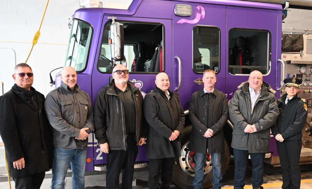 St. John's Local 1075 President Craig Smith, second from left, and SJRFES Director Sherry Colford, right, were among those who helped roll out a cancer awareness themed fire engine Jan. 27.